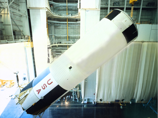 First stage of a Saturn V rocket lowered into position First stage of a Saturn V rocket lowered into position