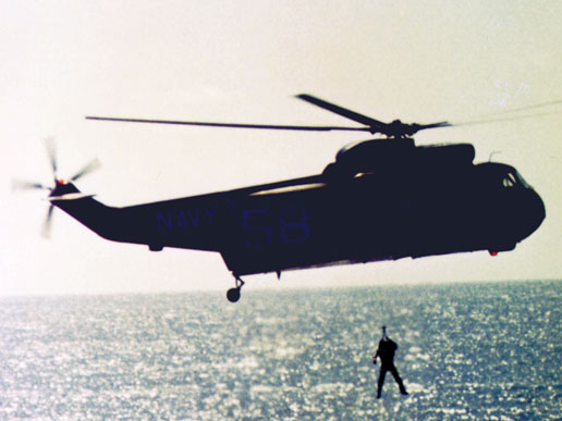 Astronaut L. Gordon Cooper, Jr., command pilot of the Gemini V spacecraft, is hoisted into a recovery helicopter.