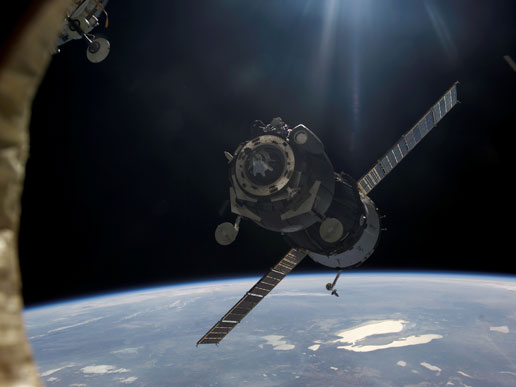 Carrying the Expedition 12 crew, a Soyuz TMA-7 approaches the International Space Station.