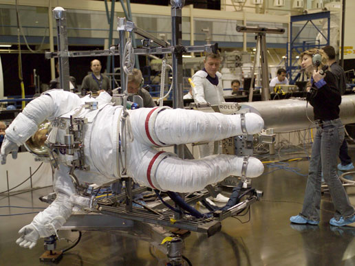 STS-121 mission specialist Piers J. Sellers trains for extravehicular activity, while Lora Bailey assists him.