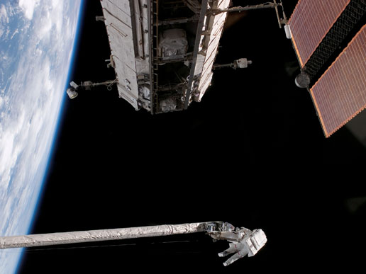 Astronaut Piers J. Sellers works on the shuttle's during the mission's first scheduled session of extravehicular activity.