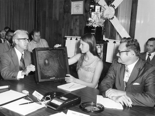 Judith Miles discusses her proposed Skylab experiment with Henry Floyd and Keith Demorest (right), both of Marshall Space Flight Center.